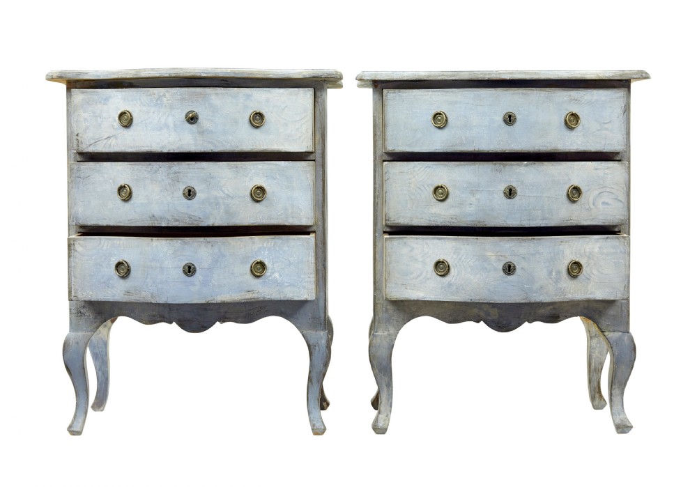 A pair of 19th-century Swedish three-drawer commodes featuring distressed pale blue painted finishes, cabriole legs, and brass hardware. View VI