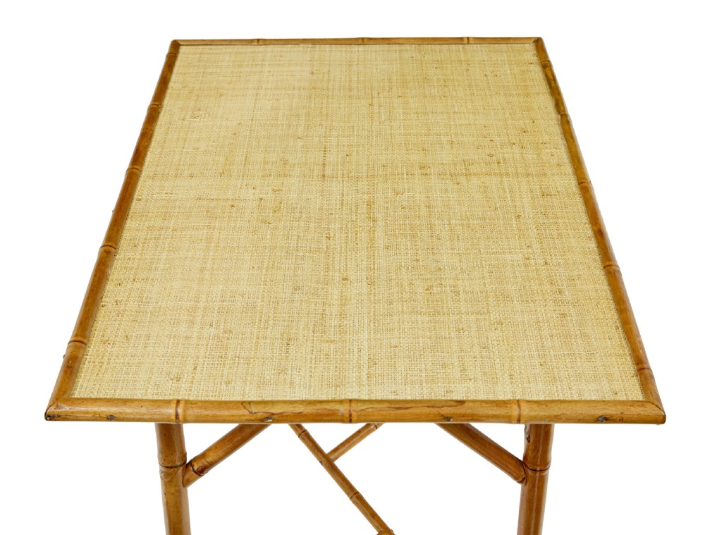 An early 20th-century bamboo side table featuring a rectangular woven hessian top panel, diagonal support struts, and outward curving lower legs. View II