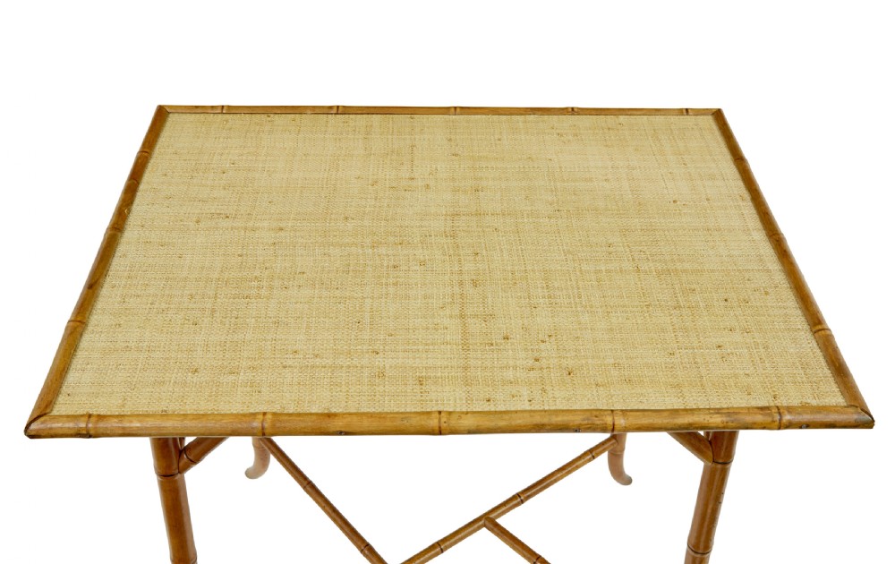An early 20th-century bamboo side table featuring a rectangular woven hessian top panel, diagonal support struts, and outward curving lower legs. View III