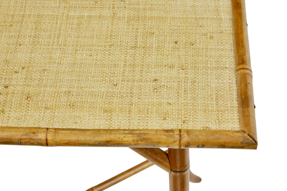 An early 20th-century bamboo side table featuring a rectangular woven hessian top panel, diagonal support struts, and outward curving lower legs. View IV