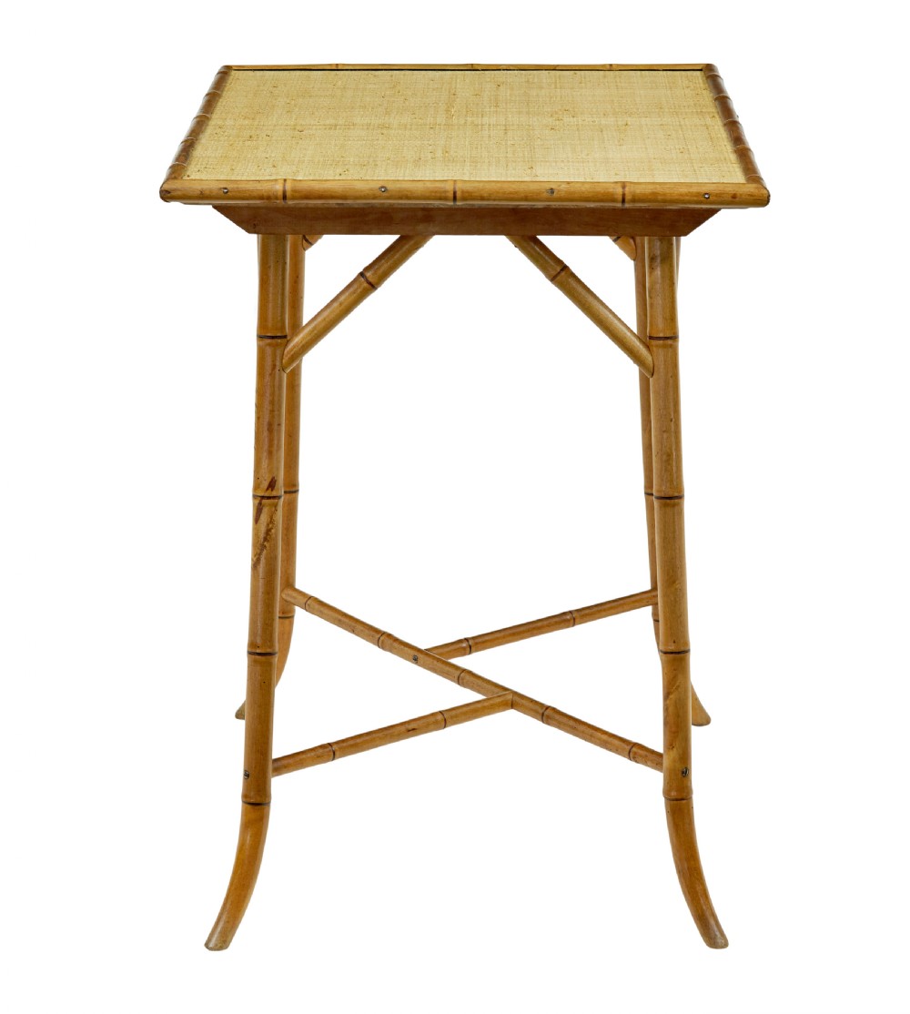 An early 20th-century bamboo side table featuring a rectangular woven hessian top panel, diagonal support struts, and outward curving lower legs. View VII