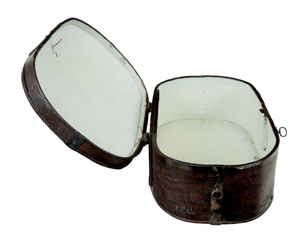 An oval dark brown 19th-century wooden box featuring hand-painted yellow and red floral folk motifs with iron bands and a latch. View VII