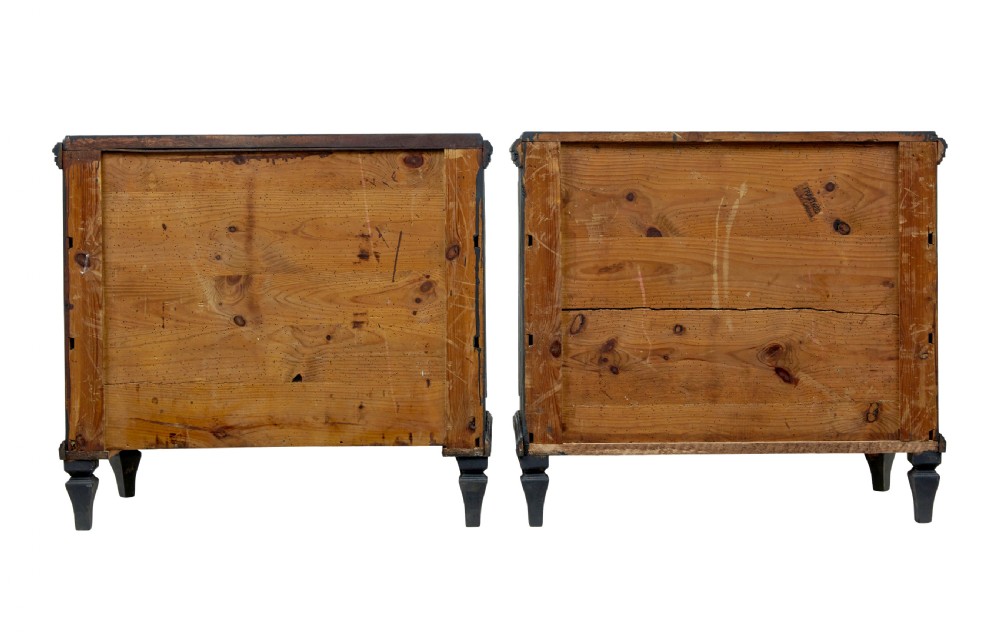 A matching pair of 19th-century Swedish black painted pine commodes, each featuring three drawers with moulded geometric panel fronts and brass drop handles. View IV