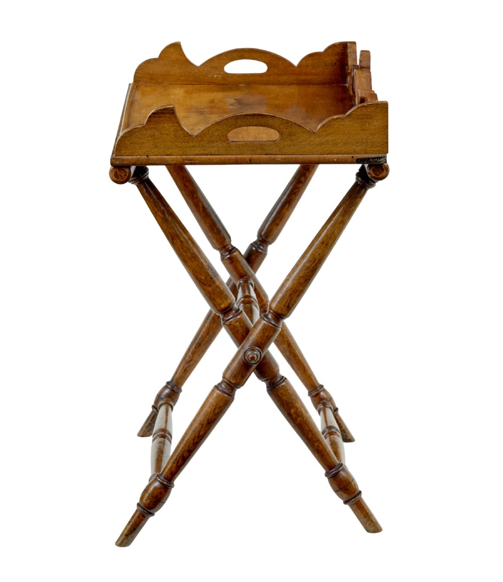 A 19th-century solid oak butler tray with carved gallery handles resting on a folding x-frame stand with turned spindles. View III