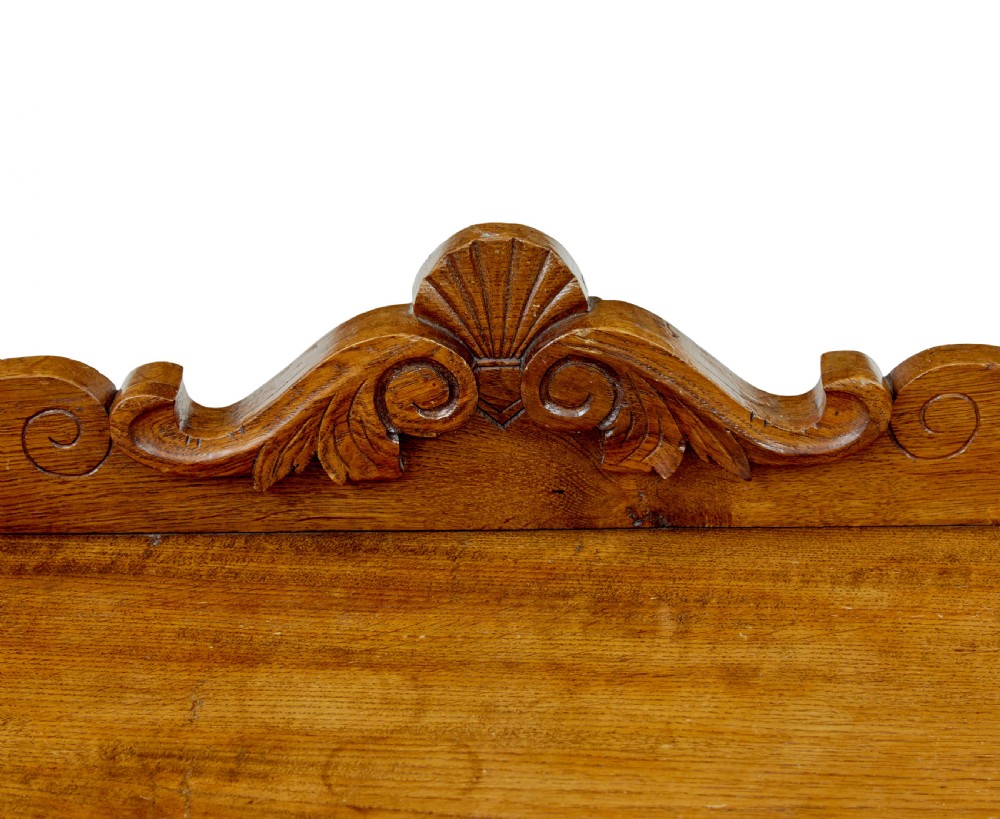A 19th-century solid oak butler tray with carved gallery handles resting on a folding x-frame stand with turned spindles. View VIII