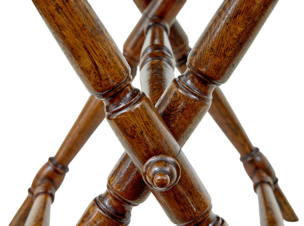 A 19th-century solid oak butler tray with carved gallery handles resting on a folding x-frame stand with turned spindles. View IX