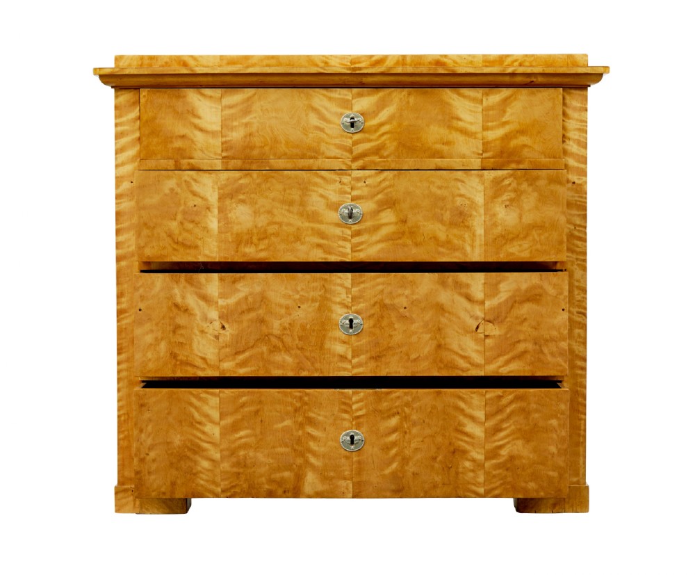 A 19th-century Swedish Biedermeier chest of drawers crafted from flame birch veneer with four horizontal drawer fronts, metal escutcheons, and square block feet. View IV