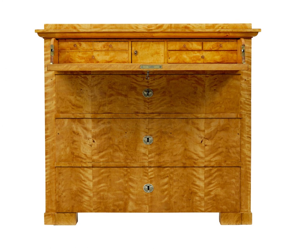 A 19th-century Swedish Biedermeier chest of drawers crafted from flame birch veneer with four horizontal drawer fronts, metal escutcheons, and square block feet. View V