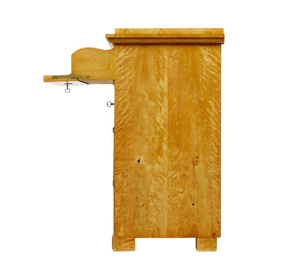 A 19th-century Swedish Biedermeier chest of drawers crafted from flame birch veneer with four horizontal drawer fronts, metal escutcheons, and square block feet. View VI