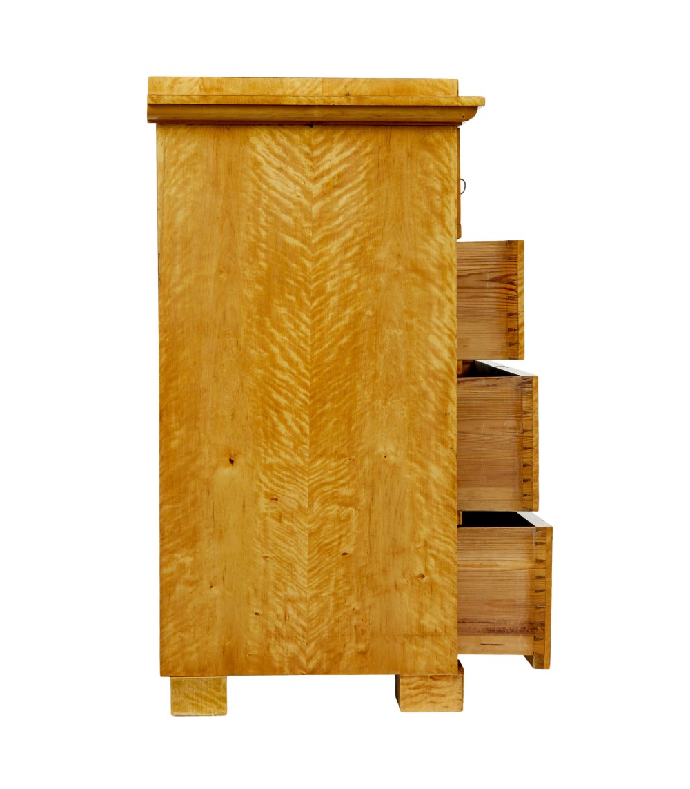 A 19th-century Swedish Biedermeier chest of drawers crafted from flame birch veneer with four horizontal drawer fronts, metal escutcheons, and square block feet. View VII