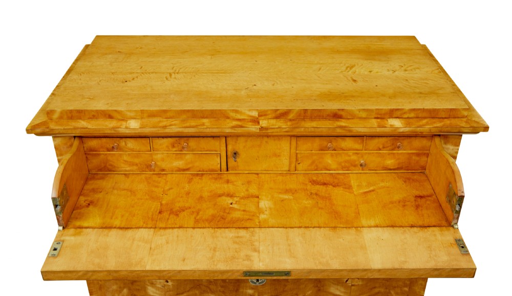 A 19th-century Swedish Biedermeier chest of drawers crafted from flame birch veneer with four horizontal drawer fronts, metal escutcheons, and square block feet. View XI