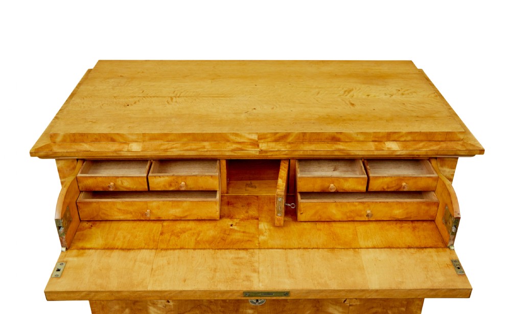 A 19th-century Swedish Biedermeier chest of drawers crafted from flame birch veneer with four horizontal drawer fronts, metal escutcheons, and square block feet. View XII