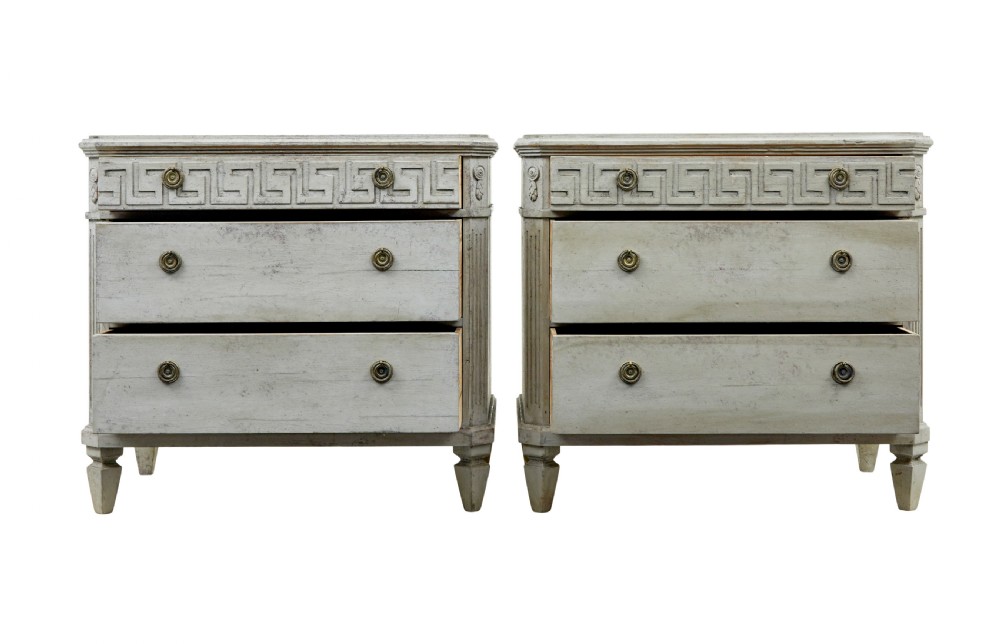 A pair of nineteenth-century Swedish Gustavian grey painted chests of drawers featuring Greek key frieze carving, fluted corners, and brass ring pulls. View II