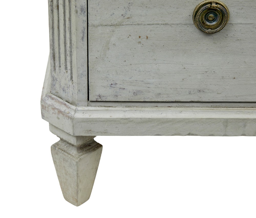 A pair of nineteenth-century Swedish Gustavian grey painted chests of drawers featuring Greek key frieze carving, fluted corners, and brass ring pulls. View VII