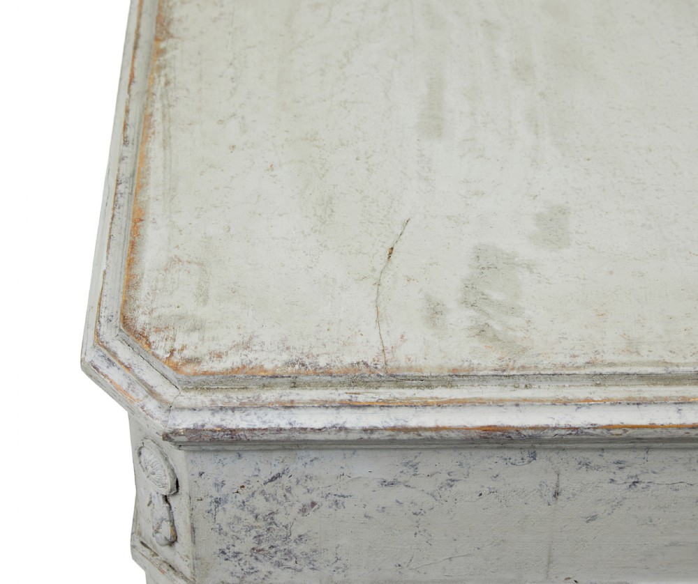 A pair of nineteenth-century Swedish Gustavian grey painted chests of drawers featuring Greek key frieze carving, fluted corners, and brass ring pulls. View X