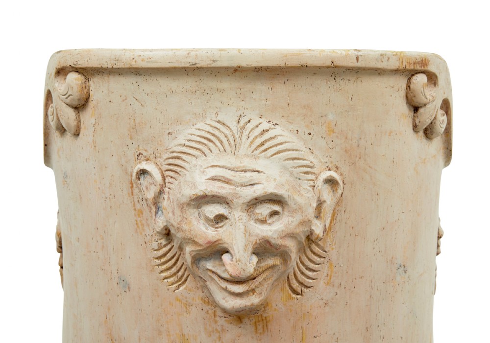 An antique cream-painted dugout armchair carved from a single timber section with relief floral scrollwork and hand-painted figures on the backrest. View V