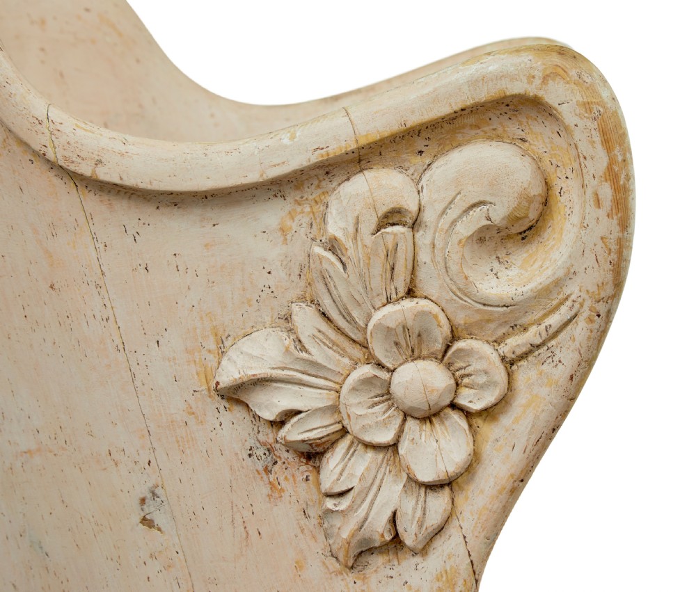 An antique cream-painted dugout armchair carved from a single timber section with relief floral scrollwork and hand-painted figures on the backrest. View VII