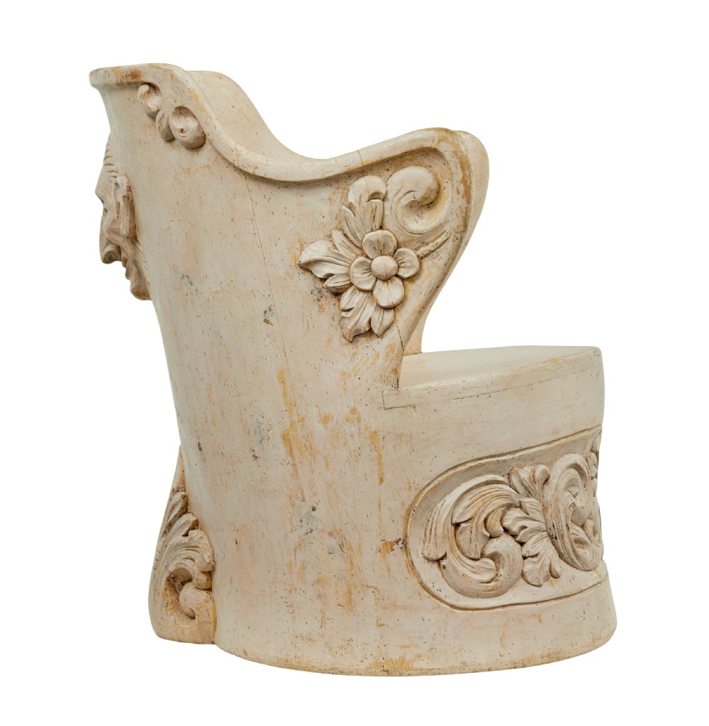 An antique cream-painted dugout armchair carved from a single timber section with relief floral scrollwork and hand-painted figures on the backrest. View VIII