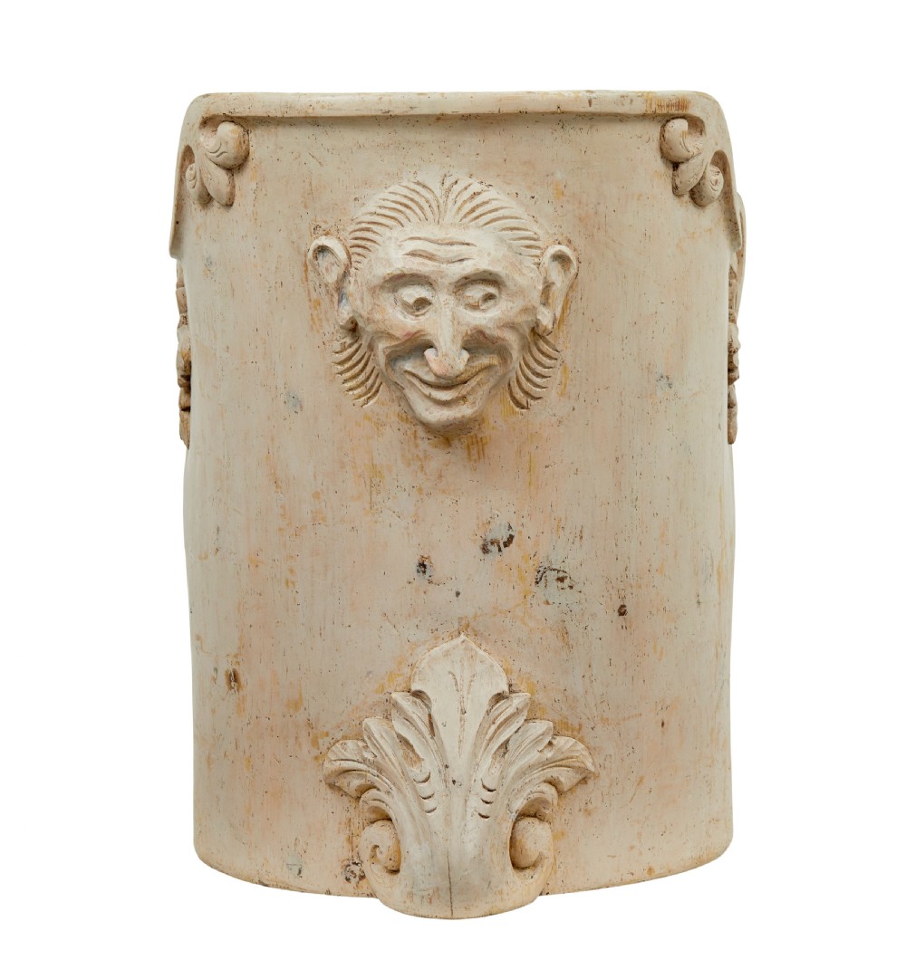 An antique cream-painted dugout armchair carved from a single timber section with relief floral scrollwork and hand-painted figures on the backrest. View IX