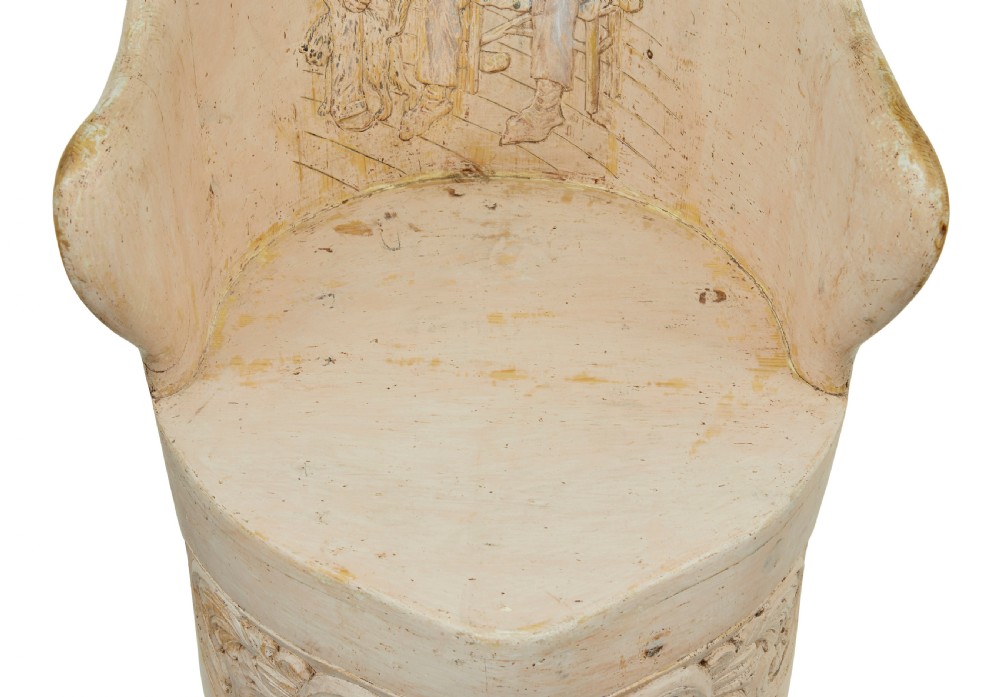 An antique cream-painted dugout armchair carved from a single timber section with relief floral scrollwork and hand-painted figures on the backrest. View XII