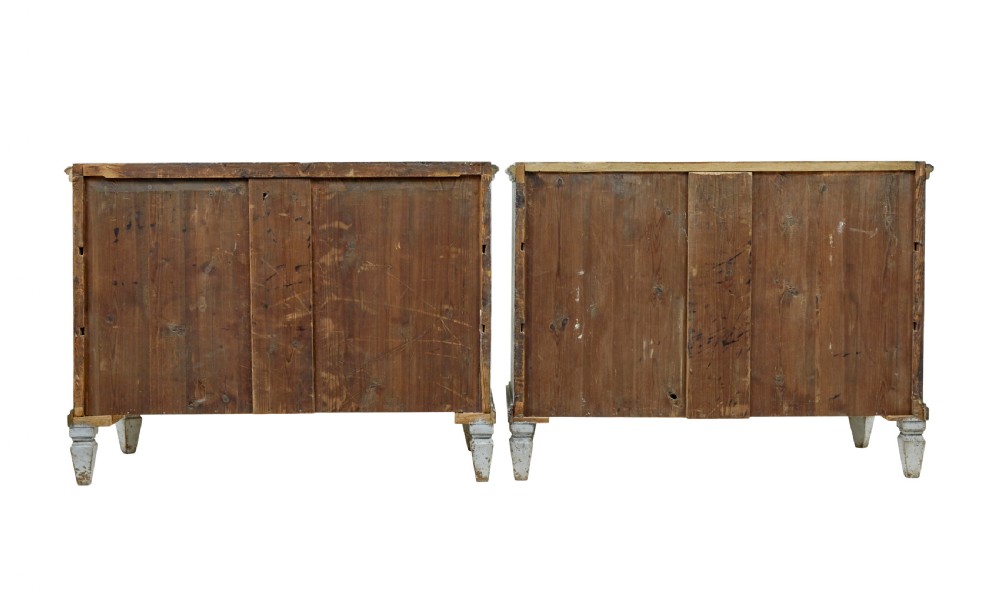 A pair of 19th-century Gustavian style painted chests of drawers with three drawers each, brass pulls, fluted side columns, and distressed pale grey paint. View IV