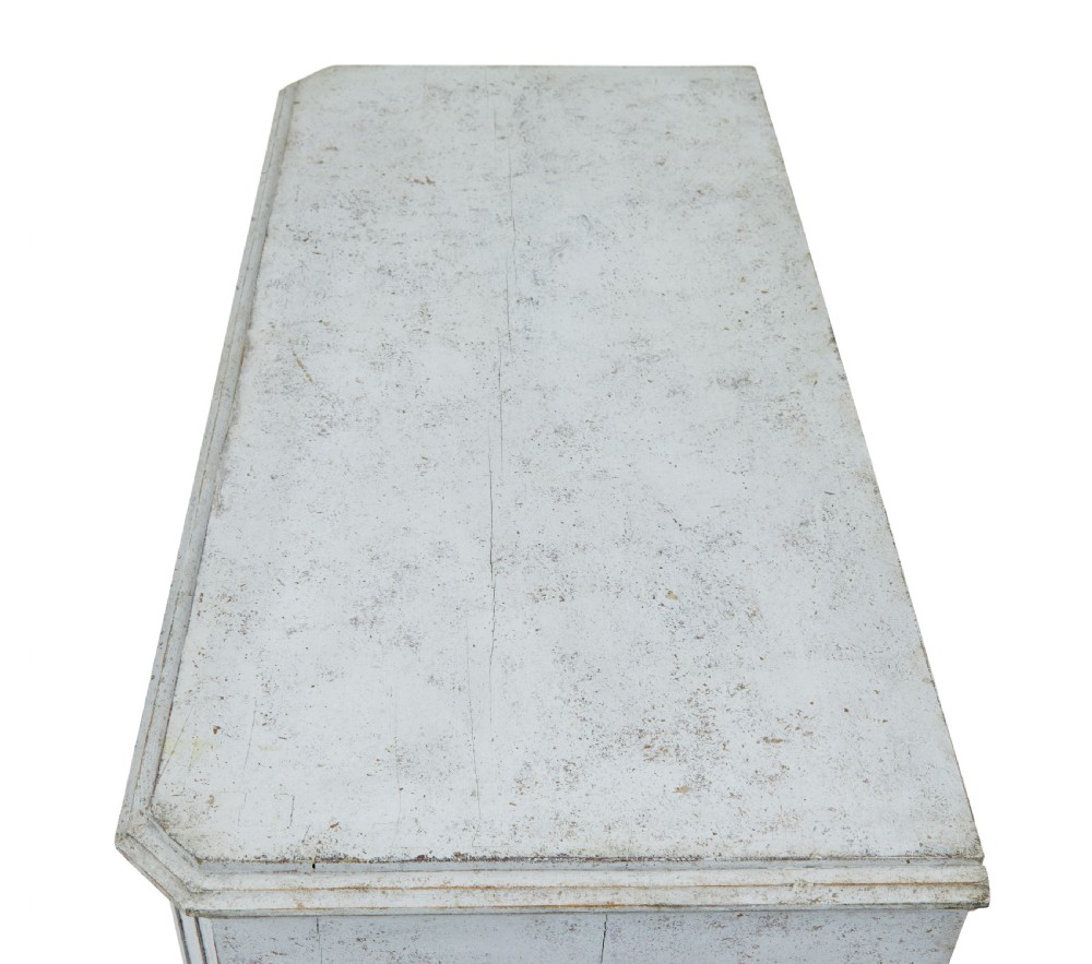 A pair of 19th-century Gustavian style painted chests of drawers with three drawers each, brass pulls, fluted side columns, and distressed pale grey paint. View VII