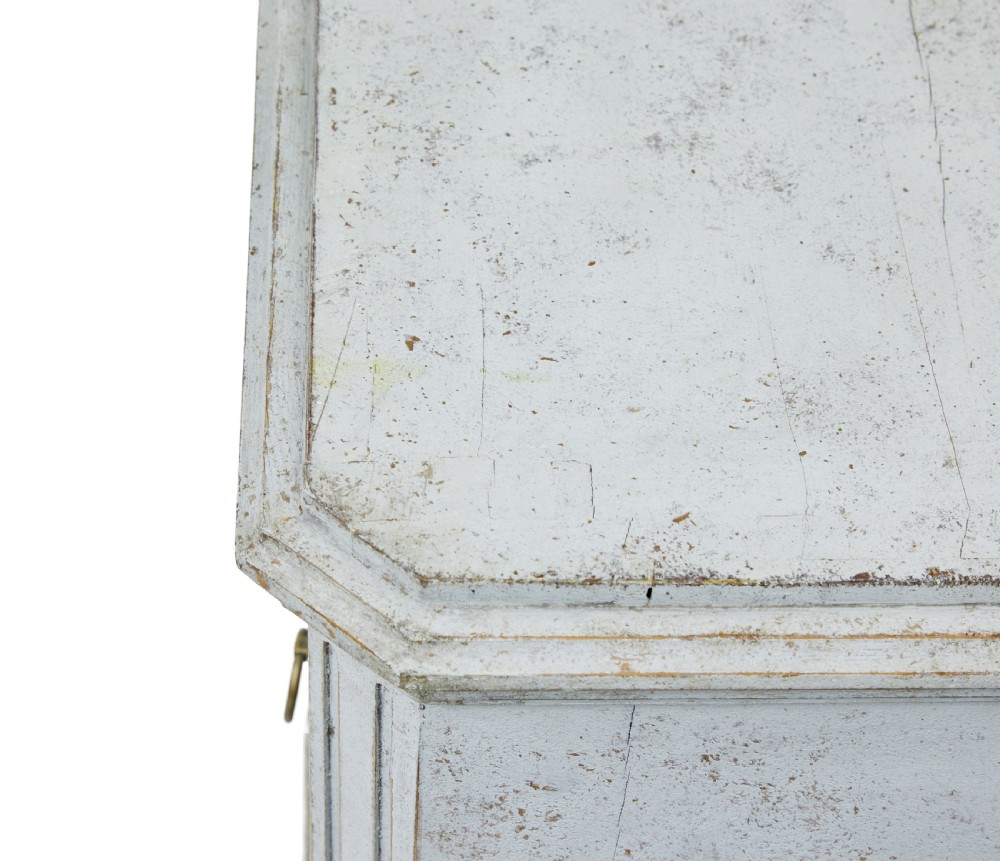 A pair of 19th-century Gustavian style painted chests of drawers with three drawers each, brass pulls, fluted side columns, and distressed pale grey paint. View VIII