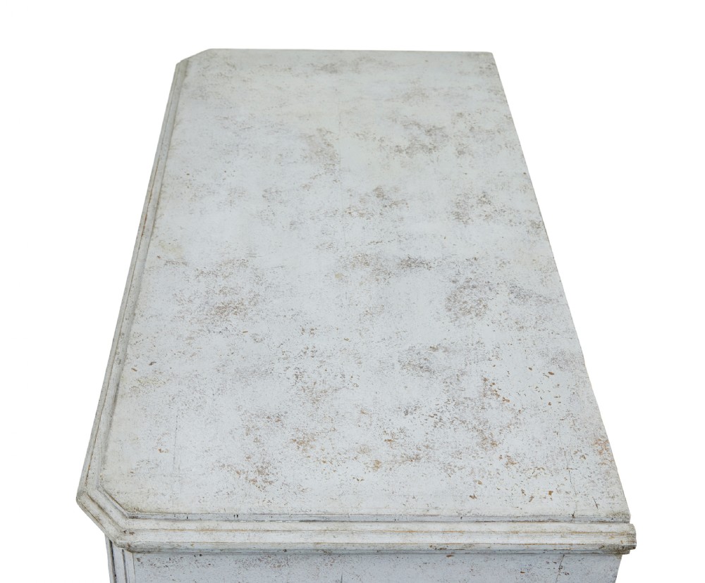 A pair of 19th-century Gustavian style painted chests of drawers with three drawers each, brass pulls, fluted side columns, and distressed pale grey paint. View IX