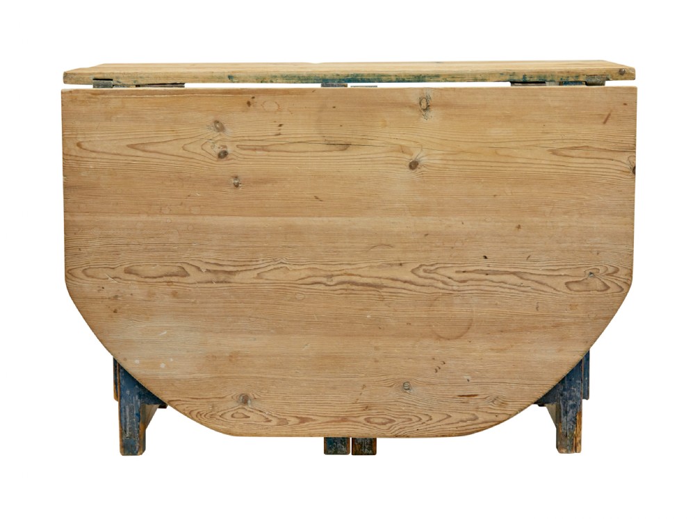 A 19th-century Swedish pine drop-leaf table featuring a raw timber top and a distressed blue painted base with a hinged leaf mechanism. View X