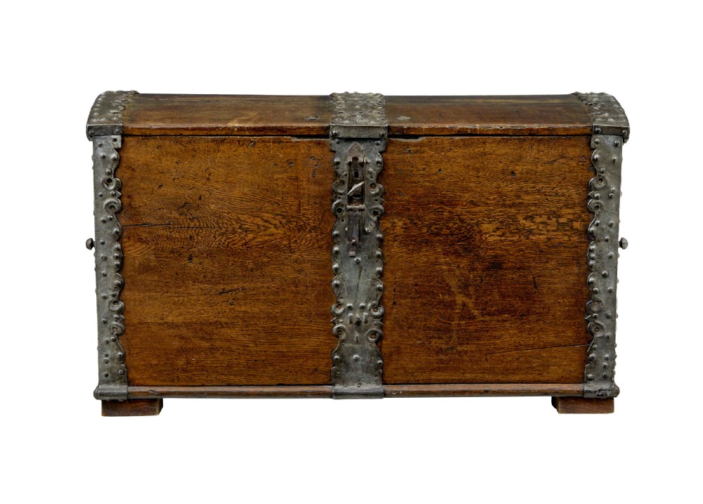 A mid-19th-century dome top oak chest featuring heavy iron strapwork mounts, side handles, and a central escutcheon. View II