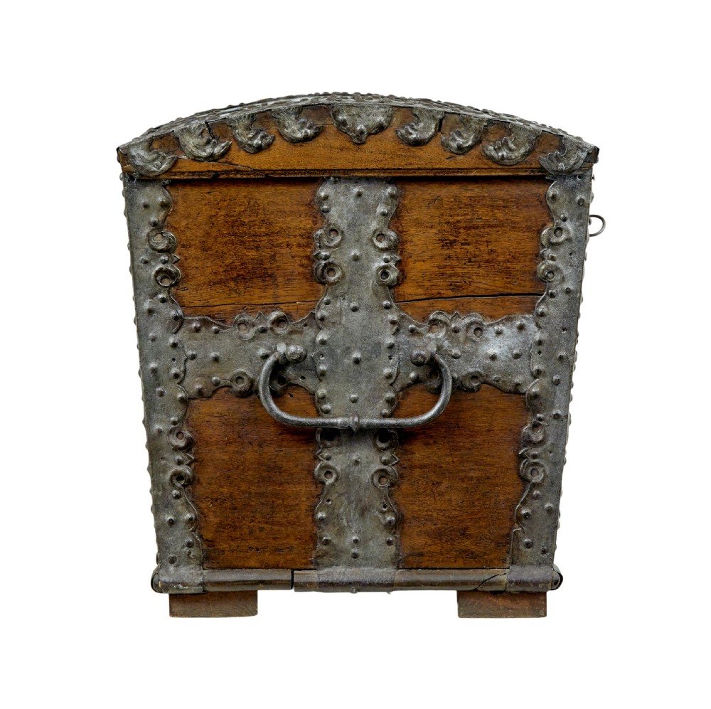 A mid-19th-century dome top oak chest featuring heavy iron strapwork mounts, side handles, and a central escutcheon. View IV