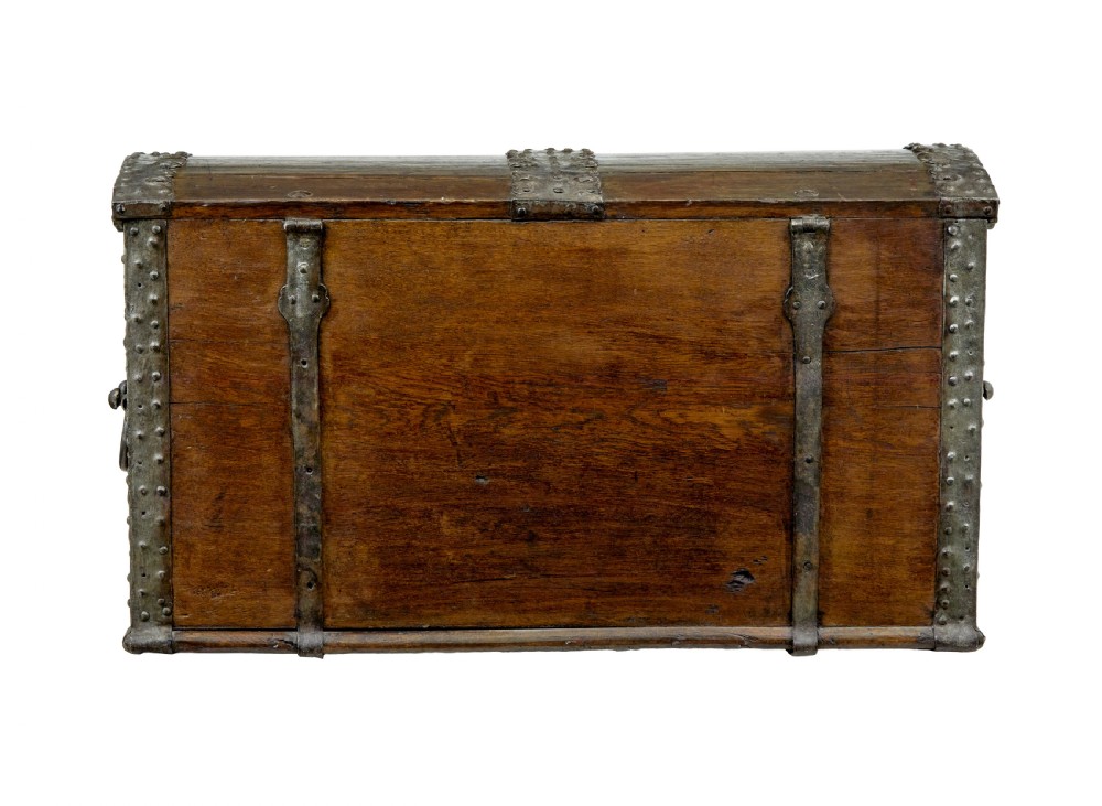 A mid-19th-century dome top oak chest featuring heavy iron strapwork mounts, side handles, and a central escutcheon. View V