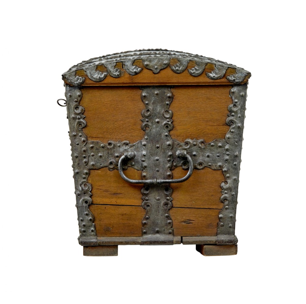 A mid-19th-century dome top oak chest featuring heavy iron strapwork mounts, side handles, and a central escutcheon. View VI
