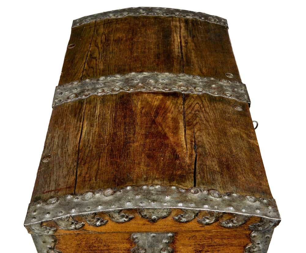 A mid-19th-century dome top oak chest featuring heavy iron strapwork mounts, side handles, and a central escutcheon. View IX