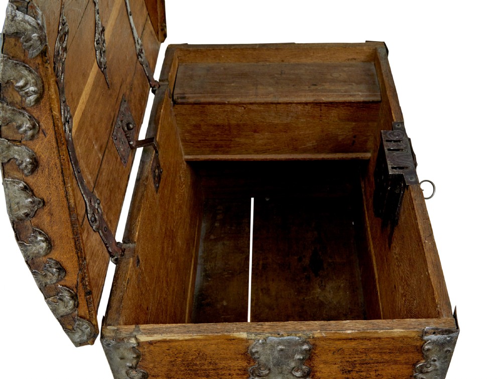 A mid-19th-century dome top oak chest featuring heavy iron strapwork mounts, side handles, and a central escutcheon. View X