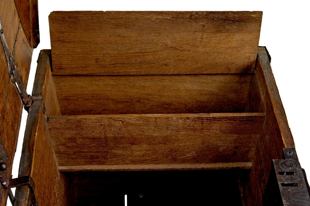 A mid-19th-century dome top oak chest featuring heavy iron strapwork mounts, side handles, and a central escutcheon. View XI