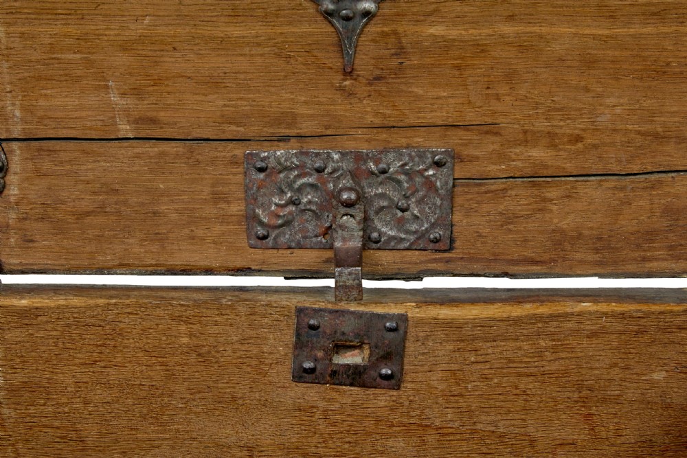 A mid-19th-century dome top oak chest featuring heavy iron strapwork mounts, side handles, and a central escutcheon. View XII