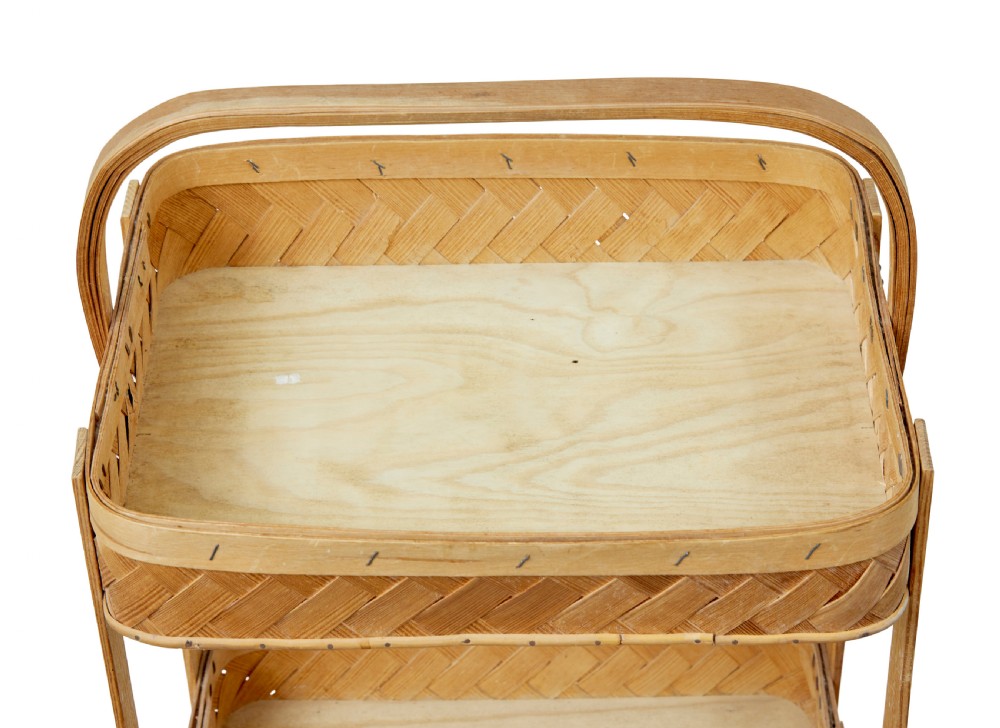 An early twentieth-century two-tier stand constructed from light-coloured woven pine splints with a bentwood arch handle and straight timber legs. View II