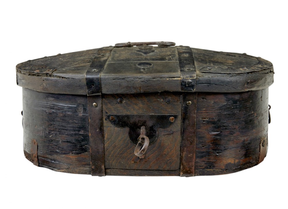 A mid-19th century Swedish oval pine strong box with dark painted finish and iron strapping.