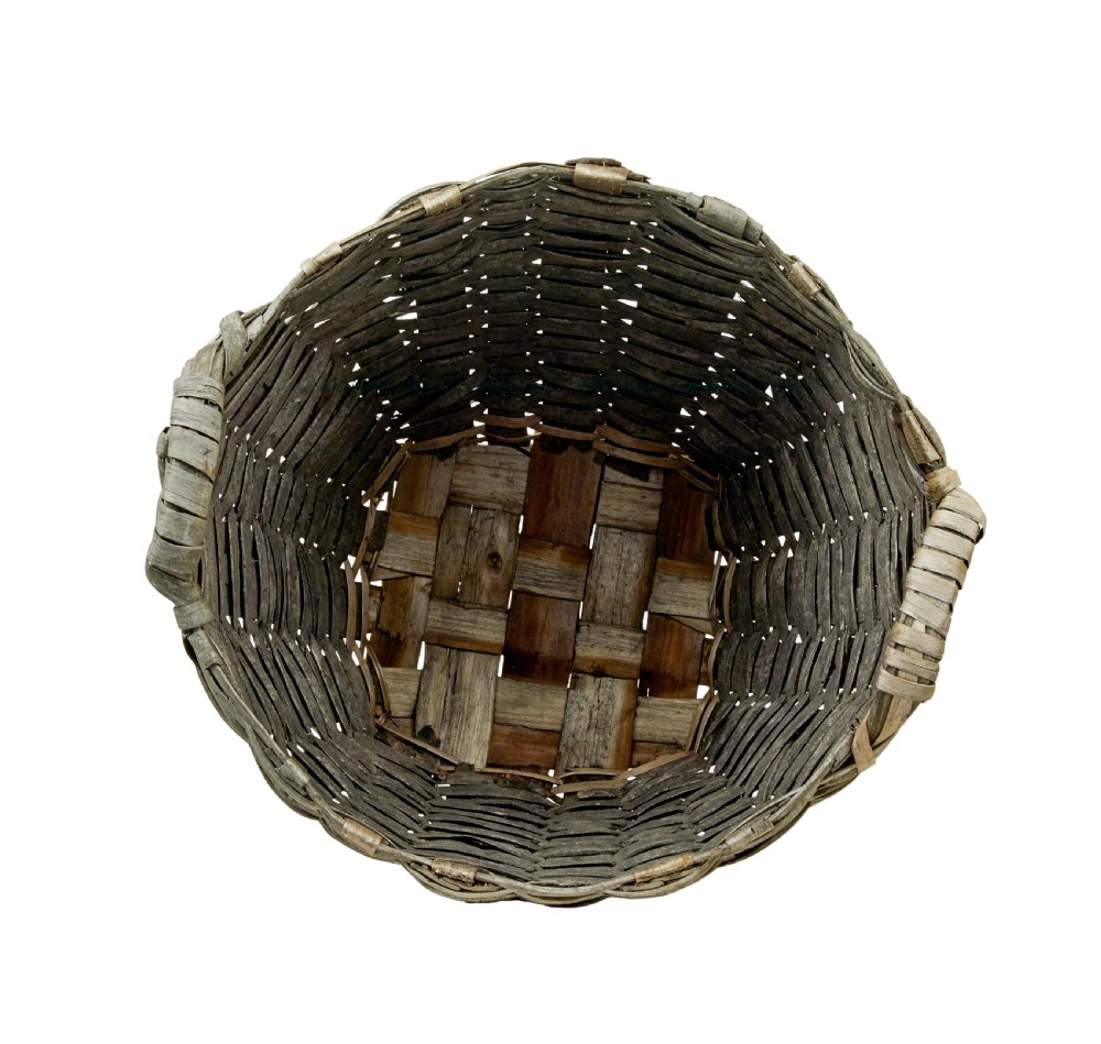 A large, weathered hand-woven basket made from thick grey pine splints with two integrated woven handles at the top rim. View VI