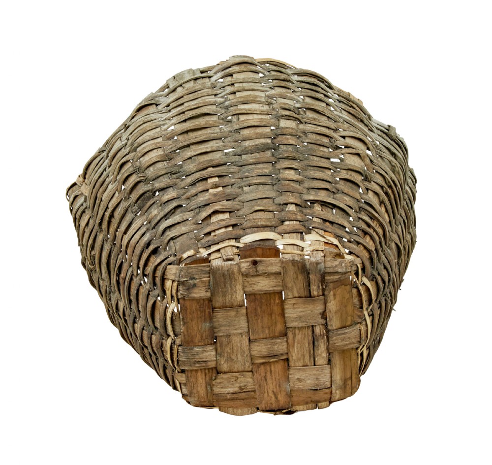 A large, weathered hand-woven basket made from thick grey pine splints with two integrated woven handles at the top rim. View VII