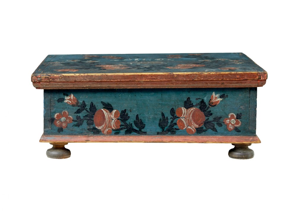 A 19th-century rectangular pine box painted teal blue with red floral motifs and small turned feet. View II