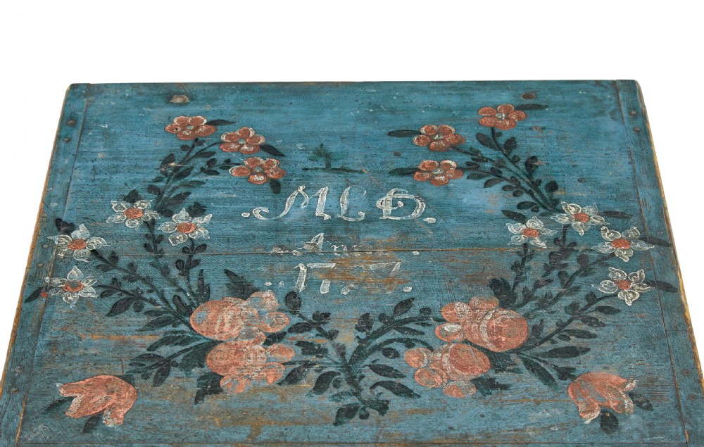 A 19th-century rectangular pine box painted teal blue with red floral motifs and small turned feet. View VII