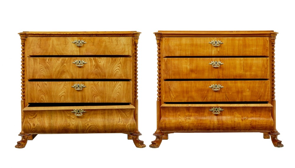 A matching pair of mid-19th-century Swedish carved elm chests of drawers featuring four drawers, barley twist side columns, carved paw feet, and brass hardware. View II