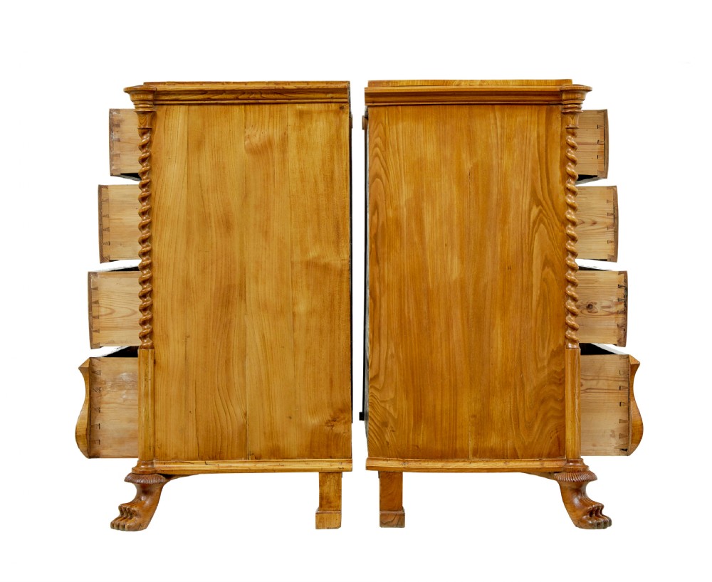 A matching pair of mid-19th-century Swedish carved elm chests of drawers featuring four drawers, barley twist side columns, carved paw feet, and brass hardware. View IV