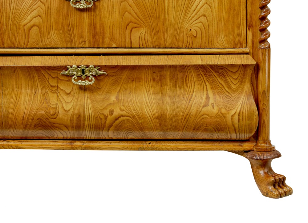 A matching pair of mid-19th-century Swedish carved elm chests of drawers featuring four drawers, barley twist side columns, carved paw feet, and brass hardware. View VI