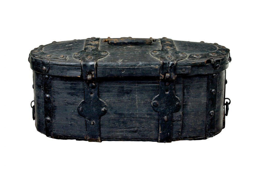 A 19th-century oval black-painted pine box featuring heavy iron straps, rivets, a top handle, and a decorative keyhole escutcheon. View IV
