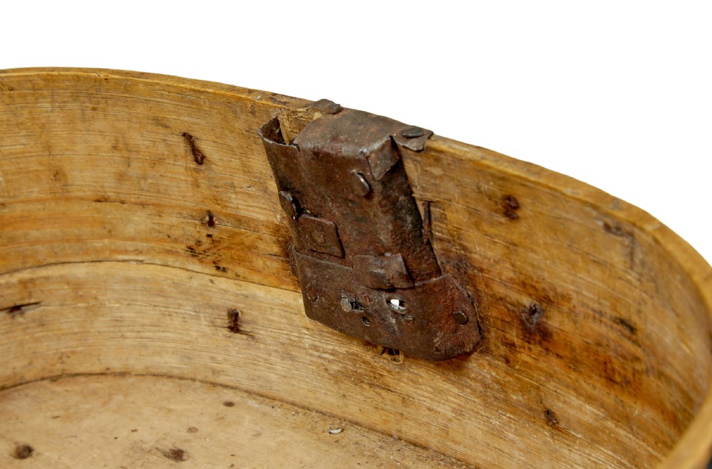 A 19th-century oval black-painted pine box featuring heavy iron straps, rivets, a top handle, and a decorative keyhole escutcheon. View VII