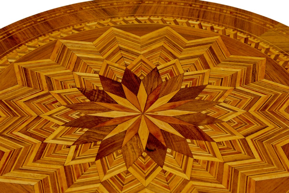 A 19th-century Italian Sorrento table featuring a circular top with geometric marquetry, a turned central column stem, and carved tripod legs. View VI