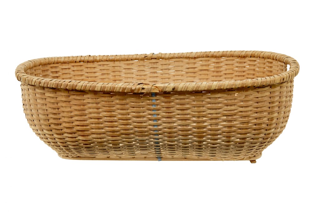 A large oval hand-woven pine basket with integrated handles and a reinforced wooden base. View II